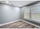 Bright bedroom featuring gray walls, wood-look floors, and a large window that provides plenty of natural light at 3755 10Th S Ave, St Petersburg, FL 33711