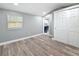 A well-lit room with wood-look floors and closet access to a stylish kitchen at 3755 10Th S Ave, St Petersburg, FL 33711