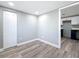 Cozy bedroom boasts wood-look floors, closet, and a glimpse of the white and navy kitchen for a modern touch at 3755 10Th S Ave, St Petersburg, FL 33711
