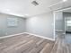 An open bedroom features a bathroom entrance, hardwood flooring, and fresh paint at 3755 10Th S Ave, St Petersburg, FL 33711