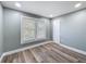 Bright bedroom featuring two windows, wood-look floors, and a double closet at 3755 10Th S Ave, St Petersburg, FL 33711