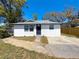 Charming home with a well-maintained lawn, a dark front door, and sidewalk that leads to the main entrance at 3755 10Th S Ave, St Petersburg, FL 33711