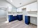 Modern kitchen featuring white cabinets, blue accents, and stylish hardware at 3755 10Th S Ave, St Petersburg, FL 33711