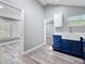 Stylish kitchen featuring custom blue cabinets, a white farmhouse sink, and wood-look floors at 3755 10Th S Ave, St Petersburg, FL 33711