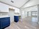 Newly renovated kitchen with white cabinets, blue base, stainless steel appliances, and a breakfast bar at 3755 10Th S Ave, St Petersburg, FL 33711
