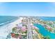 Breathtaking aerial view of a coastal city featuring pristine beaches and blue waterways at 3820 Gulf Blvd # 802, St Pete Beach, FL 33706