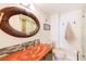 Modern bathroom with a unique, brightly colored sink, stylish mirror, and a glass-enclosed shower at 3820 Gulf Blvd # 802, St Pete Beach, FL 33706