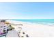 Expansive beach view with turquoise water, white sand, and tropical foliage, showcasing the coastal lifestyle at 3820 Gulf Blvd # 802, St Pete Beach, FL 33706