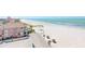 Stunning aerial view of a pristine sandy beach, turquoise water, and charming beachfront properties at 3820 Gulf Blvd # 802, St Pete Beach, FL 33706