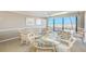 Dining area with chairs and ocean view at 3820 Gulf Blvd # 802, St Pete Beach, FL 33706