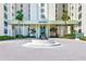 The building's entrance features lush landscaping, a fountain, and prominent signage for easy identification at 3820 Gulf Blvd # 802, St Pete Beach, FL 33706