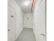 Hallway with white doors to storage units at 3820 Gulf Blvd # 802, St Pete Beach, FL 33706
