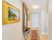 Inviting hallway featuring a decorative mirror, elegant rug, and neutral tones providing a warm and welcoming entrance at 3820 Gulf Blvd # 802, St Pete Beach, FL 33706
