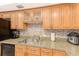 Well-organized kitchen featuring wood cabinets, stainless steel appliances, and a tiled backsplash at 3820 Gulf Blvd # 802, St Pete Beach, FL 33706
