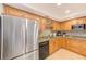 Updated kitchen featuring stainless steel appliances, wood cabinets, and tile backsplash at 3820 Gulf Blvd # 802, St Pete Beach, FL 33706