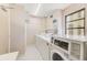 Bright laundry room featuring modern washer and dryer with operating instructions and fast drying reminder at 3820 Gulf Blvd # 802, St Pete Beach, FL 33706