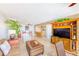 Comfortable living room showcasing tile floors, cozy seating, and large entertainment center at 3820 Gulf Blvd # 802, St Pete Beach, FL 33706