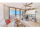 Inviting living room with ocean views, a comfortable rocking chair, and a functional workspace with built-in cabinets at 3820 Gulf Blvd # 802, St Pete Beach, FL 33706