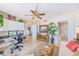Bright and airy living room featuring a workspace, built-in cabinets, and a decorative potted plant at 3820 Gulf Blvd # 802, St Pete Beach, FL 33706