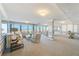 Spacious living room with large windows and ocean view at 3820 Gulf Blvd # 802, St Pete Beach, FL 33706