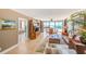 Spacious living room with tile floors, large windows providing beach views, and comfortable seating at 3820 Gulf Blvd # 802, St Pete Beach, FL 33706