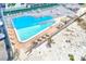 Unique heart-shaped pool surrounded by lounge chairs and lush landscaping, perfect for relaxation at 3820 Gulf Blvd # 802, St Pete Beach, FL 33706