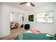 Bright bedroom featuring a ceiling fan, mirrored closet doors, and a window letting in natural light at 4038 2Nd N Ave, St Petersburg, FL 33713