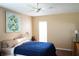 Bedroom with wood floors, a ceiling fan and a comfortable bed with a blue comforter at 408 Gloucester Blvd # 33, Sun City Center, FL 33573