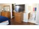 Bedroom with dresser and a TV along with access to the bathroom at 408 Gloucester Blvd # 33, Sun City Center, FL 33573