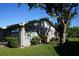 Home exterior with a well-maintained lawn and mature landscaping at 408 Gloucester Blvd # 33, Sun City Center, FL 33573