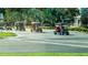 Golf carts in use on a community street, emphasizing the neighborhood's golf-friendly lifestyle at 408 Gloucester Blvd # 33, Sun City Center, FL 33573