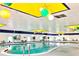 Indoor swimming pool with colorful decorations and a casual seating area surrounded by lush greenery at 408 Gloucester Blvd # 33, Sun City Center, FL 33573