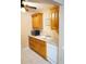 Functional kitchen featuring granite countertops, white appliances, and plenty of storage at 408 Gloucester Blvd # 33, Sun City Center, FL 33573