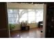 Bright sunroom with large windows, wood laminate flooring, and a ceiling fan at 408 Gloucester Blvd # 33, Sun City Center, FL 33573