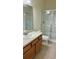 Bathroom with vanity, toilet, and glass-enclosed shower at 4133 Bismarck Palm Dr, Tampa, FL 33610