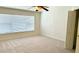 Bedroom with large window, ceiling fan, and carpet flooring at 4133 Bismarck Palm Dr, Tampa, FL 33610
