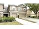Exterior of a townhome featuring attached two-car garage and neutral color scheme at 4133 Bismarck Palm Dr, Tampa, FL 33610