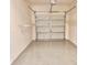 Clean garage featuring concrete floor, garage door, and wire shelving at 4133 Bismarck Palm Dr, Tampa, FL 33610