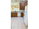 Modern kitchen featuring wood cabinets and white appliances at 4133 Bismarck Palm Dr, Tampa, FL 33610
