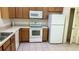 Functional kitchen featuring white appliances and ample cabinet space at 4133 Bismarck Palm Dr, Tampa, FL 33610