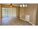 Bright living room featuring wood floors, ceiling fan, sliding glass doors to a patio, and stairs to the next level at 4133 Bismarck Palm Dr, Tampa, FL 33610