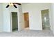 Spacious main bedroom with carpet, ceiling fan, ensuite bathroom, and walk-in closet at 4133 Bismarck Palm Dr, Tampa, FL 33610