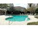 Beautiful community pool with chairs and manicured landscaping at 4133 Bismarck Palm Dr, Tampa, FL 33610
