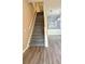 Carpeted staircase leading upstairs with wood railing and trim at 4133 Bismarck Palm Dr, Tampa, FL 33610