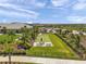 Aerial view of the community with bocce ball court, lush landscaping, and clubhouse at 4314 Graticola Rd, Wesley Chapel, FL 33543