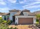 Beautiful single-story home featuring a tile roof, brick driveway, and manicured landscaping at 4314 Graticola Rd, Wesley Chapel, FL 33543