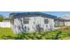 Rear exterior of house showing a small green lawn and updated air conditioning unit at 4402 Ohio Ave, Tampa, FL 33616