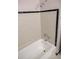 Updated bathroom featuring tiled shower with a shower head and new, bright white bathtub at 4402 Ohio Ave, Tampa, FL 33616