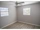 Bright bedroom with laminate floors, featuring natural light from two windows, and neutral walls at 4402 Ohio Ave, Tampa, FL 33616