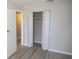 Neat bedroom with laminate floors offering closet storage with an open closet at 4402 Ohio Ave, Tampa, FL 33616